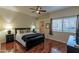 Comfortable bedroom features ceiling fan, wood floors, and closet at 11333 N 92Nd St # 1085, Scottsdale, AZ 85260