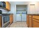 The kitchen features stone countertops and new washer/dryer set behind bifold doors at 11333 N 92Nd St # 1085, Scottsdale, AZ 85260