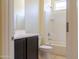 Bathroom featuring a shower-tub combination, white tile surround and espresso colored sink cabinet at 13549 W Paso Trl, Peoria, AZ 85383