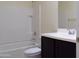 A clean bathroom featuring a white tiled shower, vanity, and toilet at 13549 W Paso Trl, Peoria, AZ 85383