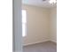 An empty bedroom with carpeted floors, a ceiling fan, and a window with blinds allowing natural light at 13549 W Paso Trl, Peoria, AZ 85383