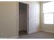 Carpeted bedroom with an open closet, neutral walls, and a bright window at 13549 W Paso Trl, Peoria, AZ 85383