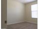 Bedroom with neutral carpet, light beige walls, and a window for natural light at 13549 W Paso Trl, Peoria, AZ 85383