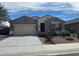 Charming single-story home featuring a two-car garage and a landscaped front yard with decorative rock at 13549 W Paso Trl, Peoria, AZ 85383