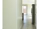View of a hallway with white walls and tile floors, leading to an open kitchen and backyard at 13549 W Paso Trl, Peoria, AZ 85383