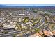 Scenic aerial view of a desert community with tiled-roof buildings, lush landscaping, and winding roads at 13700 N Fountain Hills Blvd # 135, Fountain Hills, AZ 85268