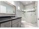 Modern bathroom featuring a glass shower with custom tile work and gray vanity at 13700 N Fountain Hills Blvd # 135, Fountain Hills, AZ 85268
