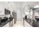 Modern kitchen with white cabinets, stainless appliances, and a sleek black countertop at 13700 N Fountain Hills Blvd # 135, Fountain Hills, AZ 85268
