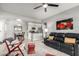 Inviting living room with a black leather sofa, stylish decor, a ceiling fan and an open flow into the kitchen at 13700 N Fountain Hills Blvd # 135, Fountain Hills, AZ 85268