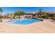 Inviting community pool with waterfall feature, lounge chairs, and lush landscaping at 13700 N Fountain Hills Blvd # 135, Fountain Hills, AZ 85268