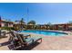 Community pool area with several lounge chairs and shade structures providing a resort-like feel at 13700 N Fountain Hills Blvd # 135, Fountain Hills, AZ 85268