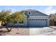Charming single-story home featuring a two-car garage, desert landscaping, and a stylish mix of siding textures at 1399 E Anna Dr, Casa Grande, AZ 85122