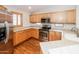 Well-equipped kitchen with stainless steel appliances, warm wood cabinets, and a large stainless fridge at 1399 E Anna Dr, Casa Grande, AZ 85122
