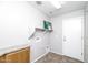 Functional laundry room features built-in shelving and tile flooring at 1399 E Anna Dr, Casa Grande, AZ 85122