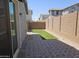 Low maintenance backyard featuring brick pavers and an artificial turf area at 14224 W Hackamore Dr, Surprise, AZ 85387