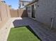 Cozy backyard showcasing pavers, low maintenance artificial turf, and a brick wall for privacy at 14224 W Hackamore Dr, Surprise, AZ 85387