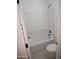 Clean bathroom showcasing a tub with shower and a white toilet at 14224 W Hackamore Dr, Surprise, AZ 85387