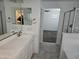Bathroom boasts double sinks and a view to the walk-in closet and bedroom at 14224 W Hackamore Dr, Surprise, AZ 85387