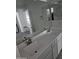 Modern bathroom features double sinks and vanity with a large mirror at 14224 W Hackamore Dr, Surprise, AZ 85387