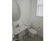 Clean, half-bathroom featuring a pedestal sink and a modern toilet at 14224 W Hackamore Dr, Surprise, AZ 85387