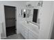 Bathroom with double sink vanity, mirrors, and access to a walk-in closet at 14224 W Hackamore Dr, Surprise, AZ 85387