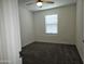 Cozy carpeted bedroom with ceiling fan and window at 14224 W Hackamore Dr, Surprise, AZ 85387
