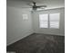 Spacious bedroom with large windows and soft gray carpet at 14224 W Hackamore Dr, Surprise, AZ 85387