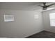 Bright bedroom features two windows and a ceiling fan for comfort at 14224 W Hackamore Dr, Surprise, AZ 85387