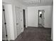 Spacious bedroom featuring neutral carpet, with multiple doors leading to en-suite bathroom and closets at 14224 W Hackamore Dr, Surprise, AZ 85387