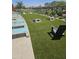Recreational area featuring a cornhole game setup, lounge chairs, and a shaded area for outdoor activities and relaxation at 14224 W Hackamore Dr, Surprise, AZ 85387