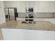 Beautiful kitchen island with stainless steel sink, granite countertop, and modern appliances at 14224 W Hackamore Dr, Surprise, AZ 85387