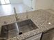 Close up of kitchen island with sink and granite countertop at 14224 W Hackamore Dr, Surprise, AZ 85387