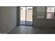 Bright living room with sliding glass doors to patio area and tile flooring at 14224 W Hackamore Dr, Surprise, AZ 85387