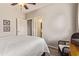 Bedroom with access to an ensuite bath, hardwood floor, and wicker chair at 14250 W Wigwam Blvd # 2126, Litchfield Park, AZ 85340