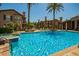 Community pool and jacuzzi surrounded by lush landscaping and seating at 14250 W Wigwam Blvd # 2126, Litchfield Park, AZ 85340