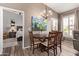 Inviting dining area with modern chandelier, neutral colors and view to main bedroom at 14250 W Wigwam Blvd # 2126, Litchfield Park, AZ 85340