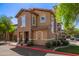 Charming two-story townhome with desert landscaping, quaint side door and red sidewalk trim at 14250 W Wigwam Blvd # 2126, Litchfield Park, AZ 85340