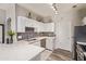 Well-lit kitchen showcasing white cabinets, modern backsplash, stainless steel appliances, and hardwood floors at 14250 W Wigwam Blvd # 2126, Litchfield Park, AZ 85340
