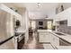 Charming kitchen with stainless steel appliances, white cabinetry, and view to dining area at 14250 W Wigwam Blvd # 2126, Litchfield Park, AZ 85340