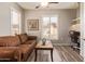 Cozy living room with a leather couch, coffee table, and a desk in the corner at 14250 W Wigwam Blvd # 2126, Litchfield Park, AZ 85340