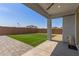 A well-kept backyard including artificial turf and brick paving under a covered patio at 14269 W El Cortez Pl, Surprise, AZ 85387