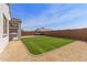 A lovely backyard with artificial turf, stone landscaping, and covered patio at 14269 W El Cortez Pl, Surprise, AZ 85387