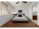 Comfortable bedroom features a ceiling fan, and a large bed with a patterned duvet at 14269 W El Cortez Pl, Surprise, AZ 85387