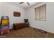 Bedroom with a window, a ceiling fan, and toys, including a race car track on the floor at 14269 W El Cortez Pl, Surprise, AZ 85387