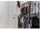 Organized walk-in closet filled with an array of clothing and accessories on multiple racks at 14269 W El Cortez Pl, Surprise, AZ 85387