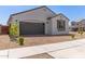 Charming single-Gathering home with a paved driveway and desert landscaping at 14269 W El Cortez Pl, Surprise, AZ 85387