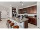Beautiful kitchen with granite countertops, stainless steel appliances, and a breakfast bar with seating at 14269 W El Cortez Pl, Surprise, AZ 85387