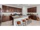 Beautiful kitchen with an island, granite countertops, stainless steel appliances, and dark wood cabinets at 14269 W El Cortez Pl, Surprise, AZ 85387
