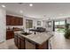Modern kitchen with granite countertops and stainless steel appliances, connecting seamlessly to the living area at 14269 W El Cortez Pl, Surprise, AZ 85387