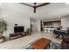 Open-concept living room with a ceiling fan and lots of natural light at 14269 W El Cortez Pl, Surprise, AZ 85387